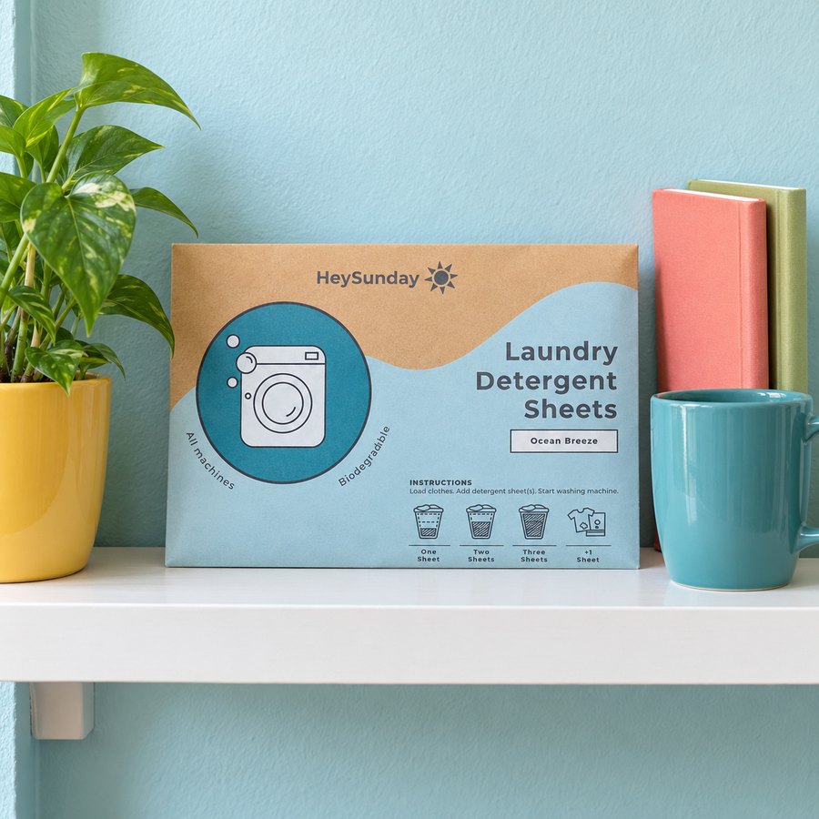 The HeySunday pack standing on a small wall shelf next to a plant and a mug