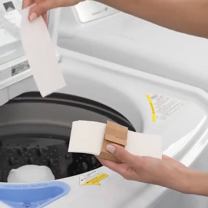 Two HeySunday laundry sheets going into a washing machine