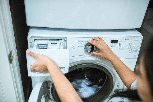 a person putting detergent in washer