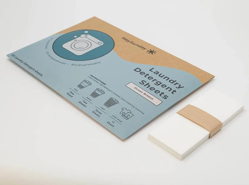 A pack of HeySunday Laundry Detergent Sheets with a stack of sheets