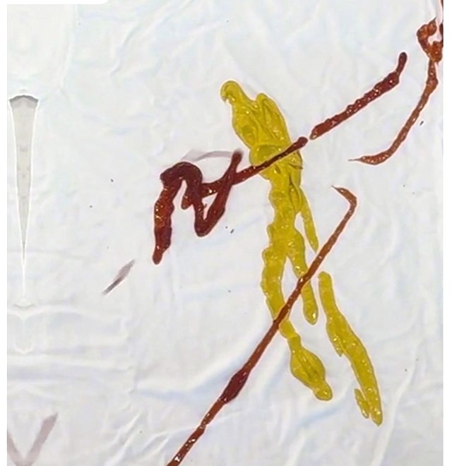 A white shirt with ketchup and mustard on it